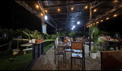 Soda Ojoche’s outdoor dining patio strung with warm string lights in the evening